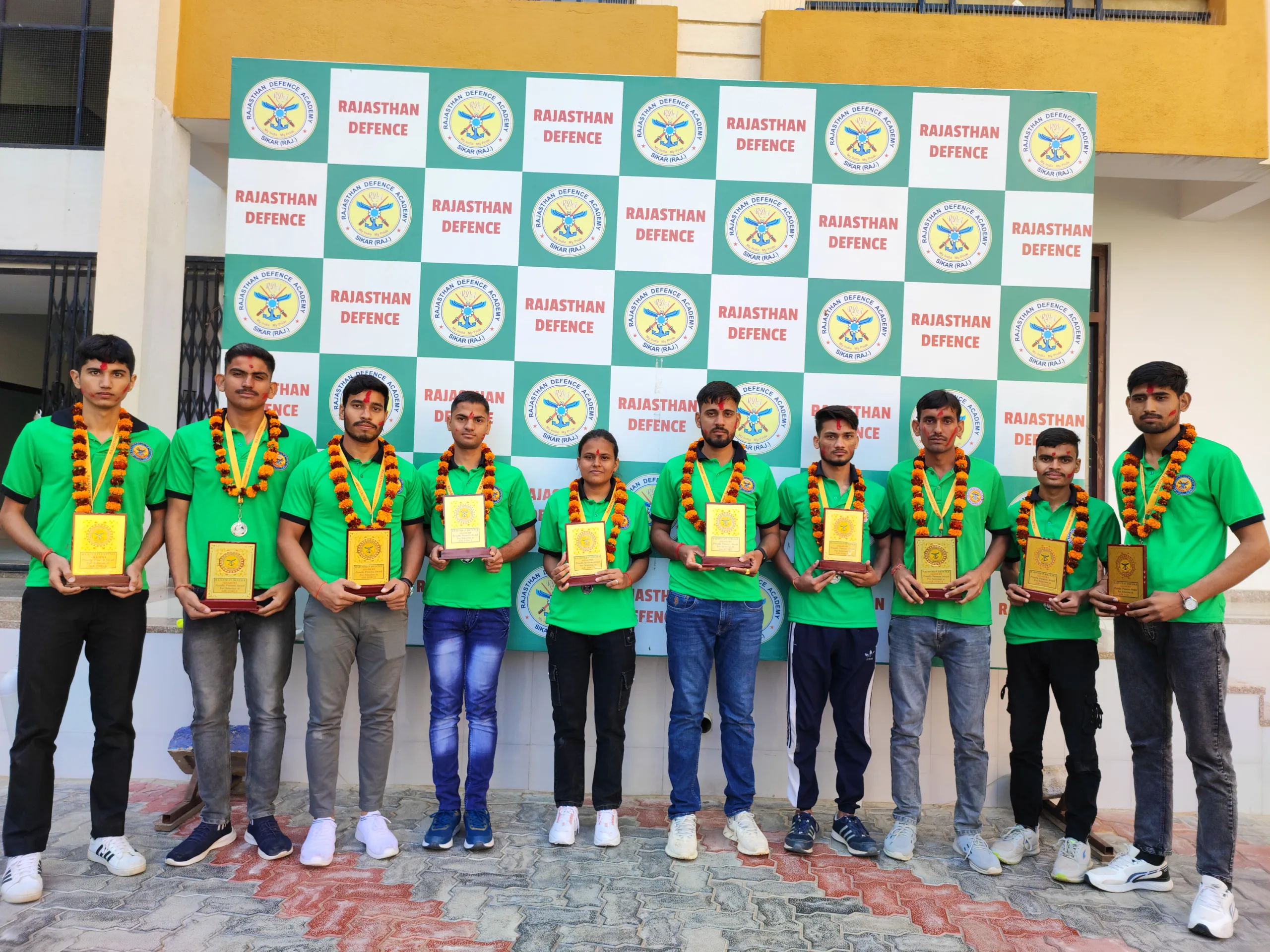some boys and girls are holding prizes in their hand in front of a banner